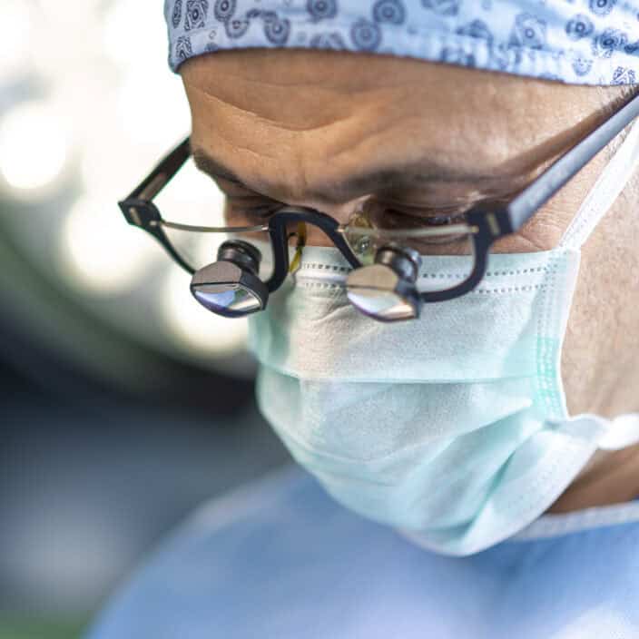 Close up face of surgeon man looking away with protective mask.