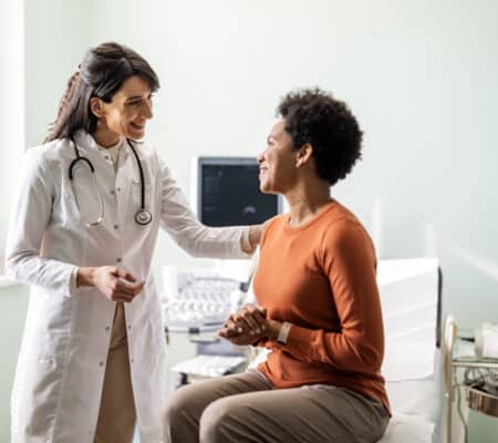 Female primary care provider reassuring a patient