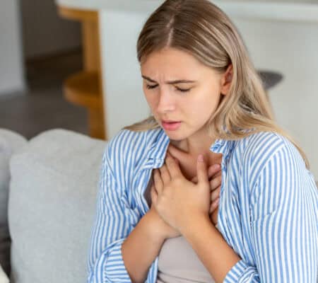 Young woman having chest pain