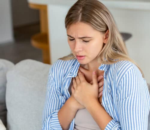 Young woman having chest pain