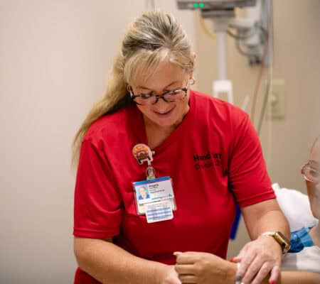 Hand Day 2024 nurse evaluating patient's hand