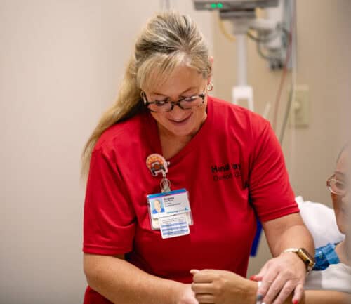 Hand Day 2024 nurse evaluating patient's hand