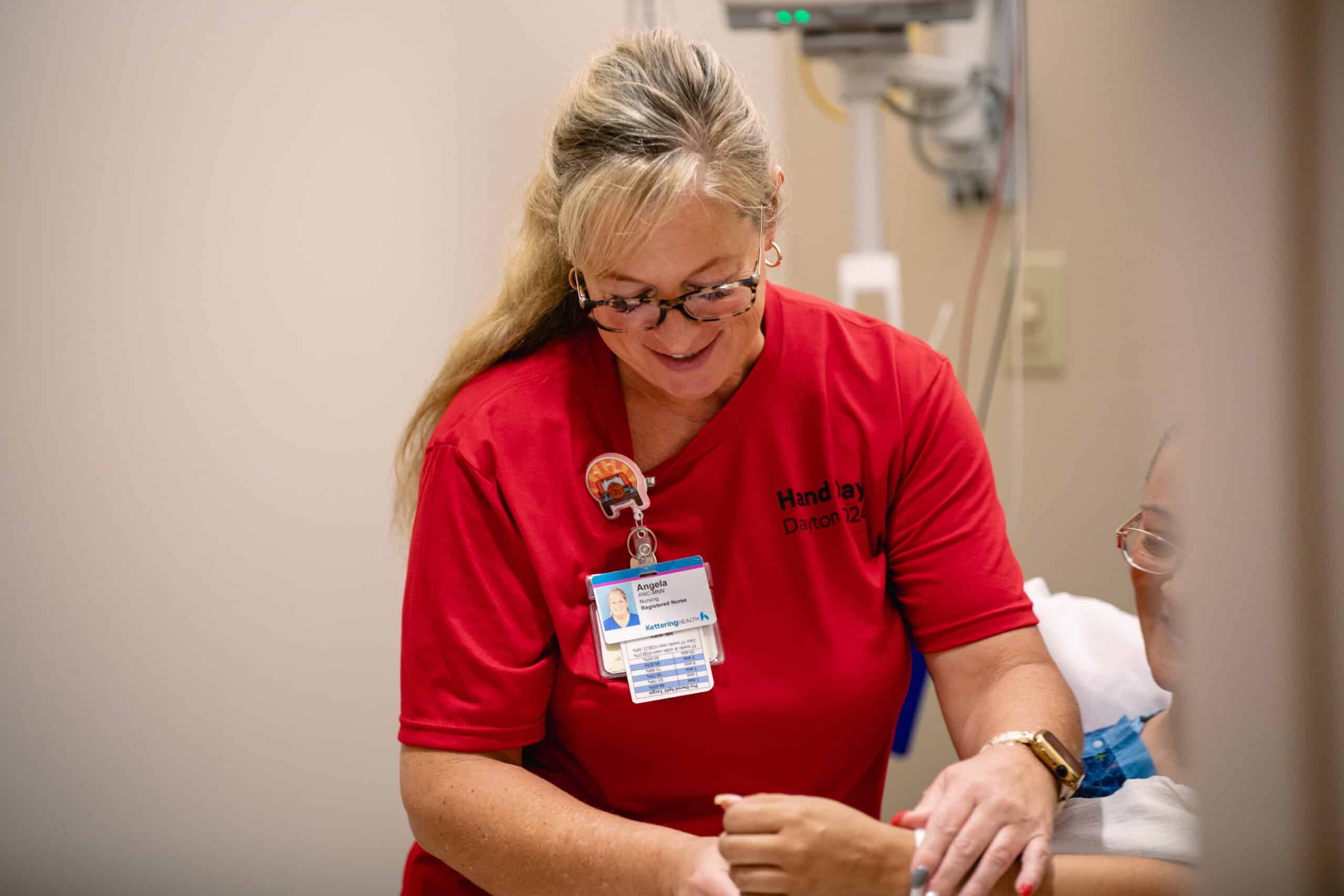 Hand Day 2024 nurse evaluating patient's hand