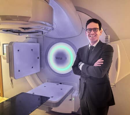 Doctor Paravati standing in front of. The radiology machine