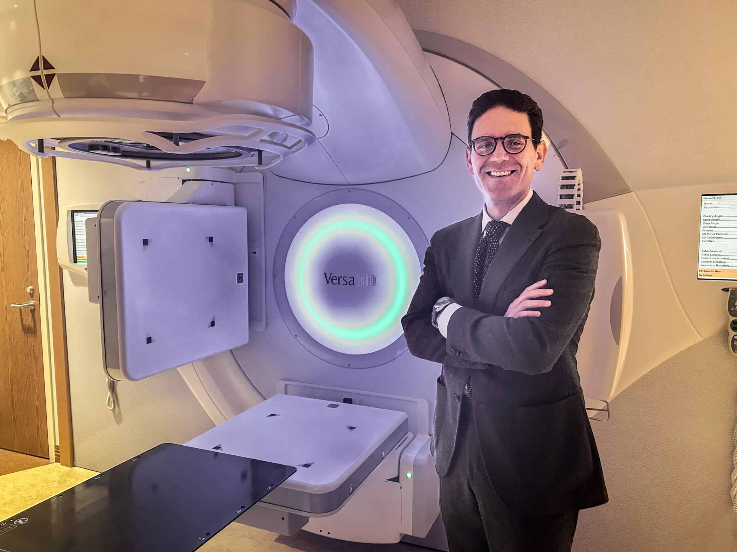 Doctor Paravati standing in front of. The radiology machine