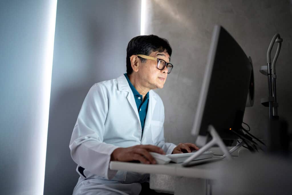 Doctor looking at monitor.