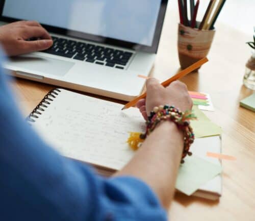 Woman working at a wooden desk