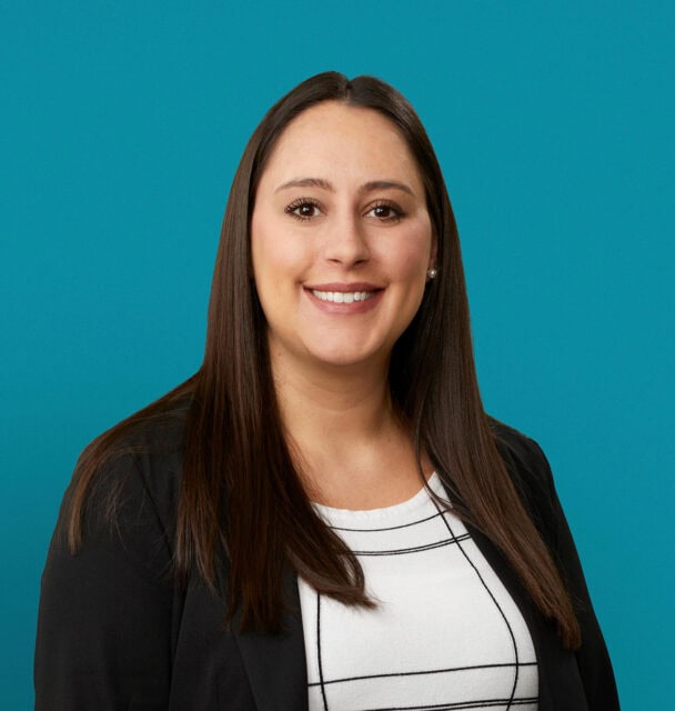 Professional headshot of Alyssa R. Wetzel, APRN-CNP, smiling in business attire against teal background