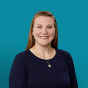 Professional headshot of Amy Knotts, APRN-CNP, smiling in navy top against teal background