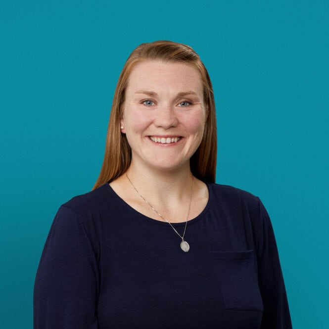 Professional headshot of Amy Knotts, APRN-CNP, smiling in navy top against teal background