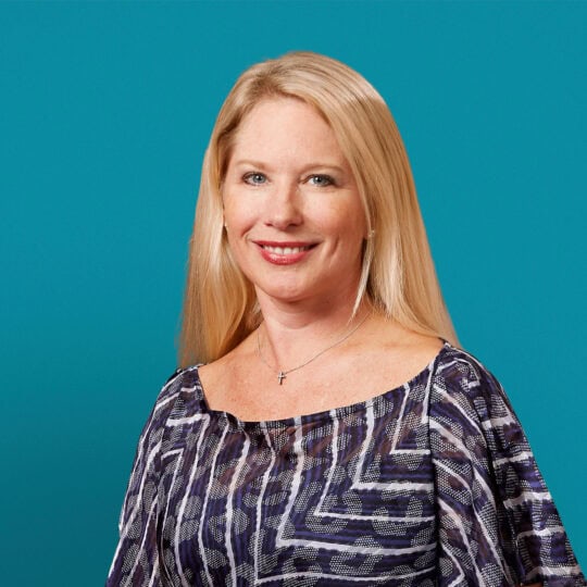 Professional headshot of Dr. Amy M. Byerly against teal background