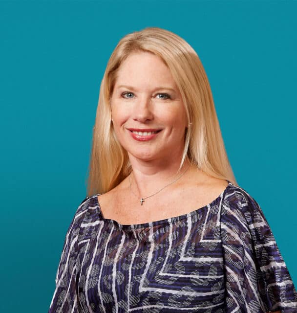 Professional headshot of Dr. Amy M. Byerly against teal background