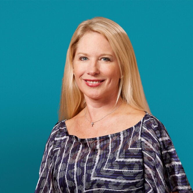 Professional headshot of Dr. Amy M. Byerly against teal background