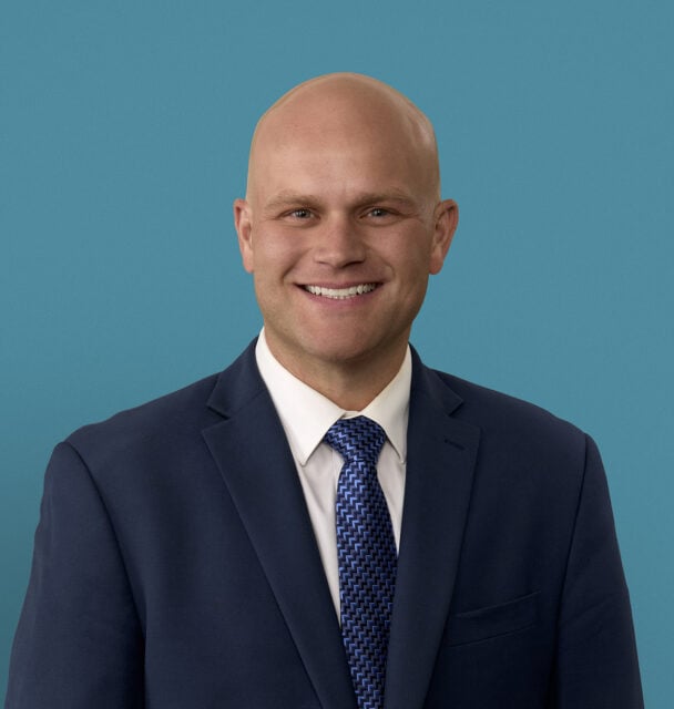 Professional headshot of Andrew M. Steffensmeier, MD in navy suit with blue tie