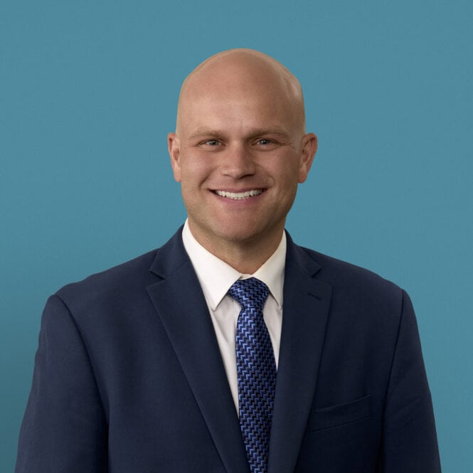 Professional headshot of Andrew M. Steffensmeier, MD in navy suit with blue tie