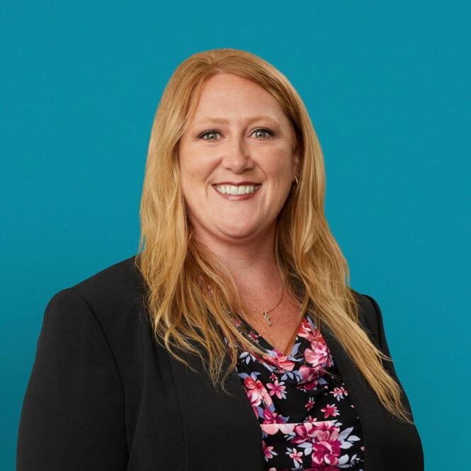 Professional headshot of Angela Keeton, APRN-CNP, smiling in black blazer against turquoise background