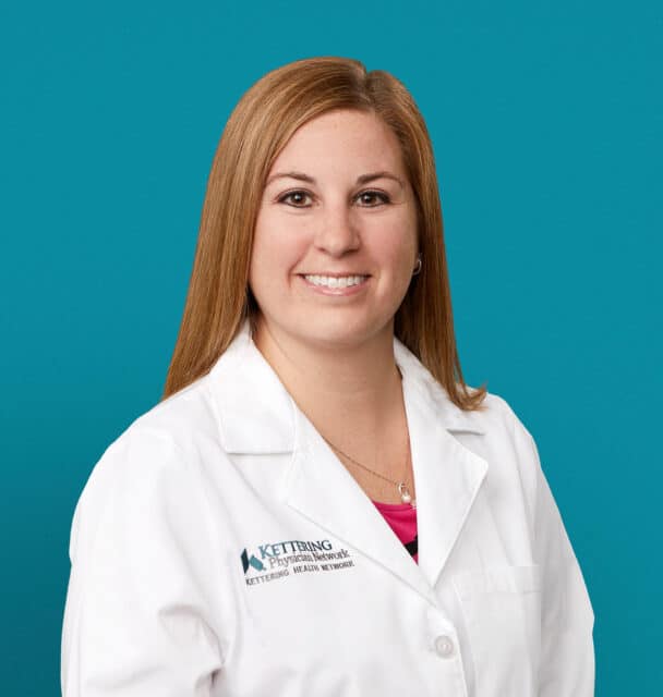 Professional headshot of Angela M. Prickett, APRN-CNP in white medical coat