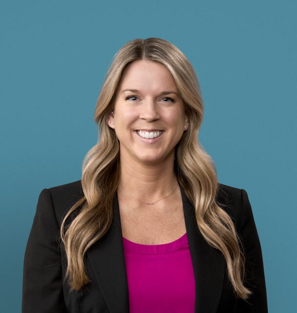 Professional headshot of Anna Bergman, APRN-CNP in black blazer with pink top
