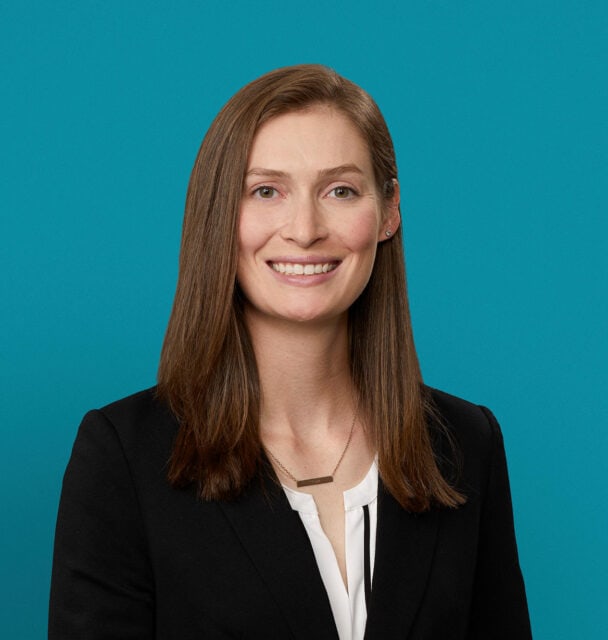 Professional headshot of Annabeth Barry, PA-C, smiling in dark blazer against teal background