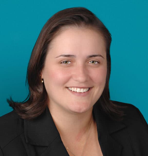 Professional headshot of Annette E. Bombrys, DO smiling in black blazer