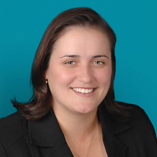 Professional headshot of Annette E. Bombrys, DO smiling in black blazer