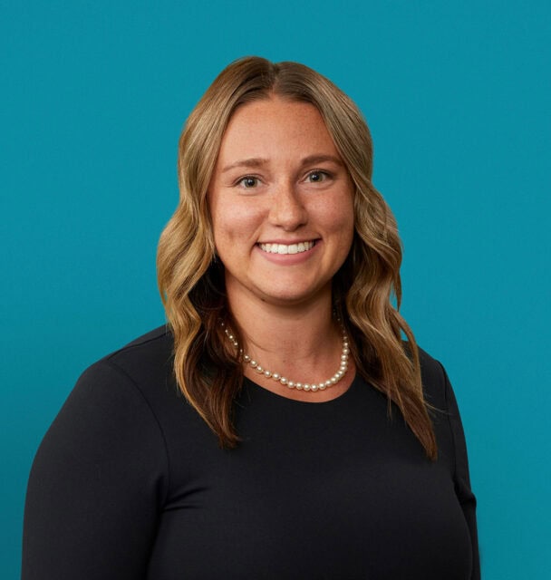 Professional headshot of Arielle Hafle, APRN-CNP, wearing black top with pearl necklace