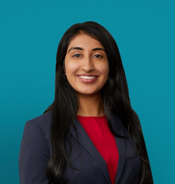 Professional headshot of Dr. Bahar K. Cheema in navy blazer and red top.