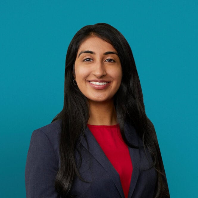 Professional headshot of Dr. Bahar K. Cheema in navy blazer and red top.
