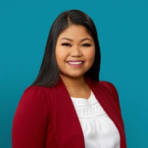 Professional headshot of Bernadette Medina, APRN-CNP in red blazer against teal background
