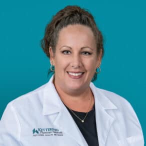 Professional headshot of Brandie L. McGuire, APRN-CNP in white medical coat