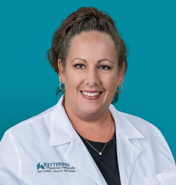 Professional headshot of Brandie L. McGuire, APRN-CNP in white medical coat