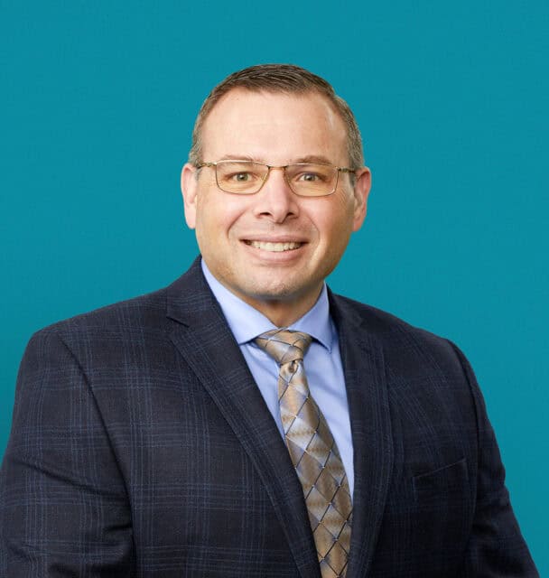 Professional headshot of Brandon L. Ryhlick, DO in dark suit and tie
