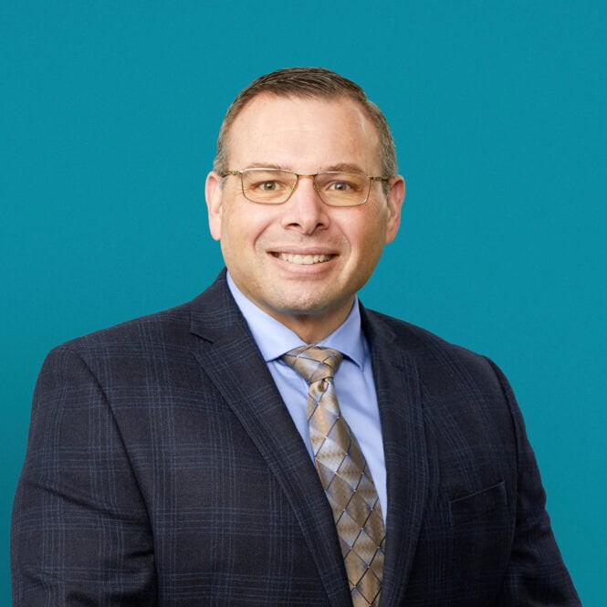 Professional headshot of Brandon L. Ryhlick, DO in dark suit and tie