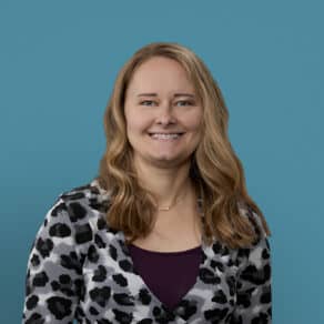 Professional headshot of Caitlyn Frantz, APRN-CNP, smiling in leopard print cardigan