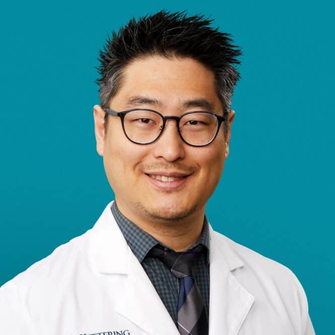 Professional headshot of Dr. Christopher H. Lee in white coat smiling at camera
