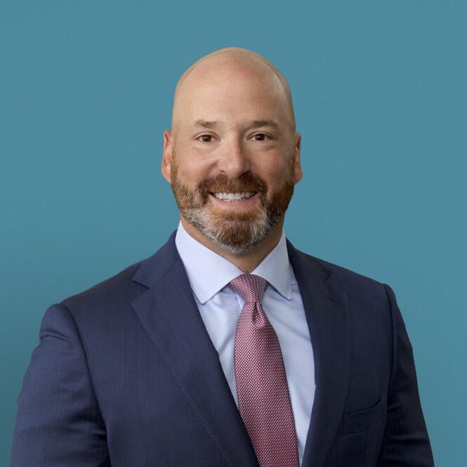 Professional headshot of Christopher J. Strauchon, DO in navy suit against teal background