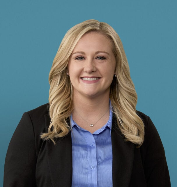 Professional headshot of Cori K. Luthman, PA-C in black blazer and blue shirt