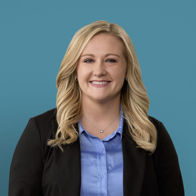 Professional headshot of Cori K. Luthman, PA-C in black blazer and blue shirt