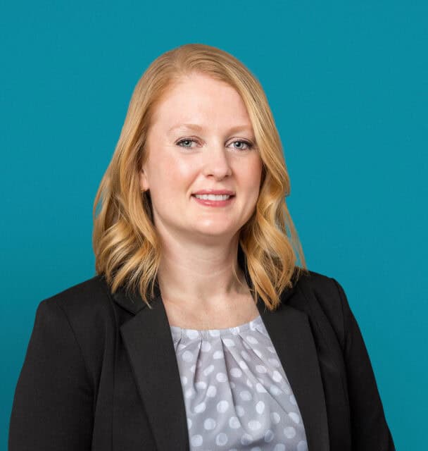 Professional headshot of Danielle Bridges, APRN-CNP in black blazer against teal background