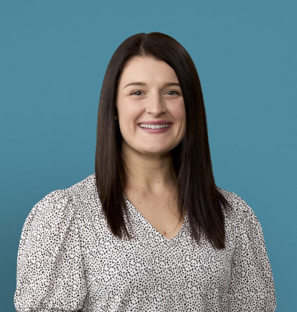 Professional headshot of Delani Deckard, APRN-CNP, smiling in polka dot blouse
