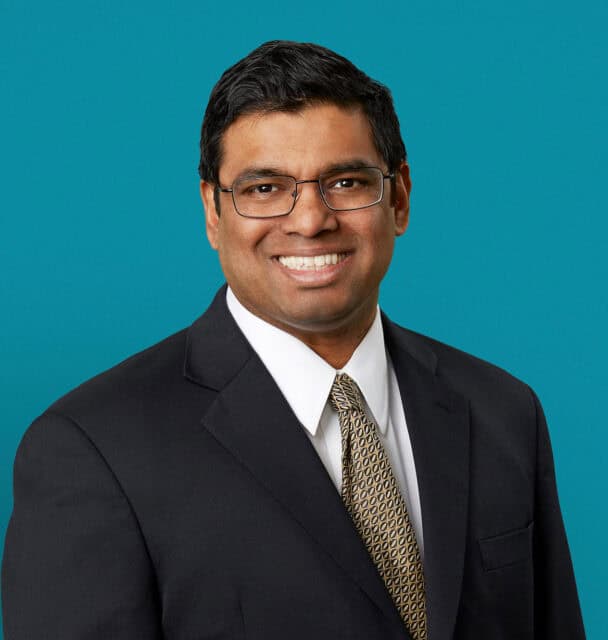 Professional headshot of Don J. Mascarenhas, MD in dark suit against teal background