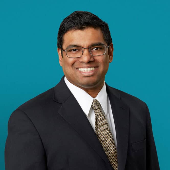 Professional headshot of Don J. Mascarenhas, MD in dark suit against teal background