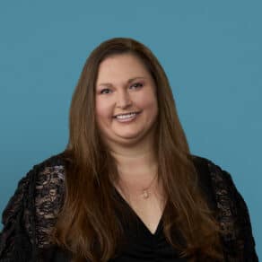 Professional headshot of Elissa Reed, APRN-CNP, smiling in black lace top