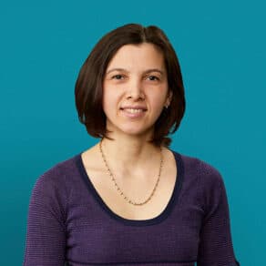 Professional headshot of Dr. Emanuela Cimpeanu smiling against teal background
