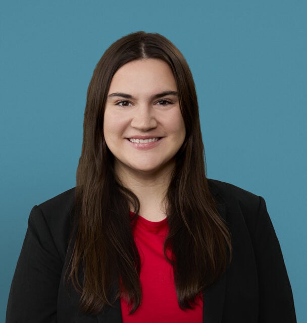 Professional headshot of Emma Boyd, PA-C, smiling in business attire against blue background