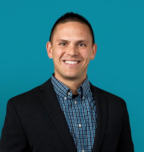 Professional headshot of Eric Bowers, APRN-CNP in dark suit jacket against teal background