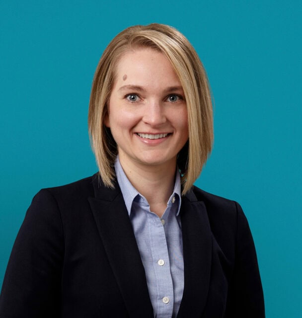 Professional headshot of Eva M. Linkenbach, APRN-CNP in business attire against teal background