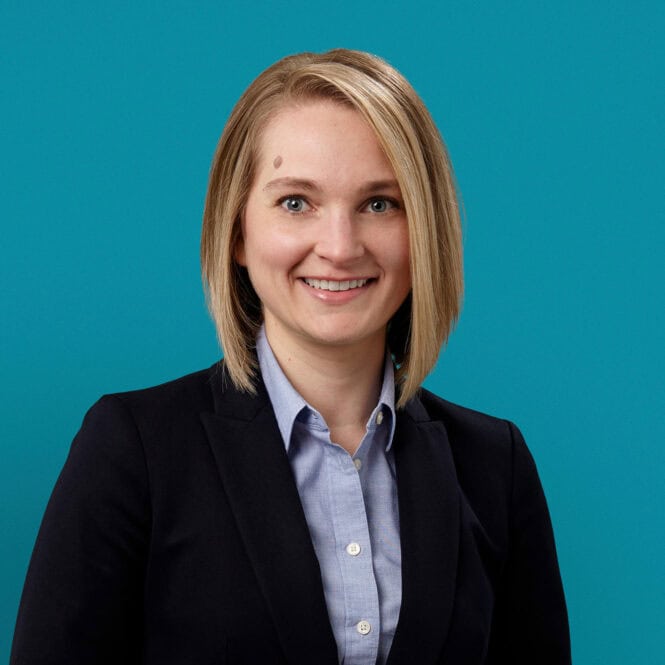 Professional headshot of Eva M. Linkenbach, APRN-CNP in business attire against teal background