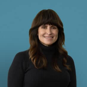 Professional headshot of Evelyn Robbins, APRN-CNP, smiling in black turtleneck sweater