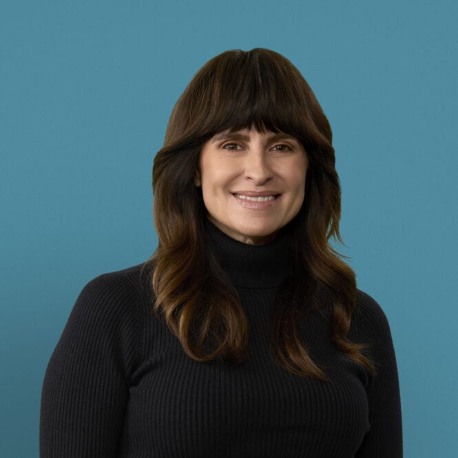 Professional headshot of Evelyn Robbins, APRN-CNP, smiling in black turtleneck sweater